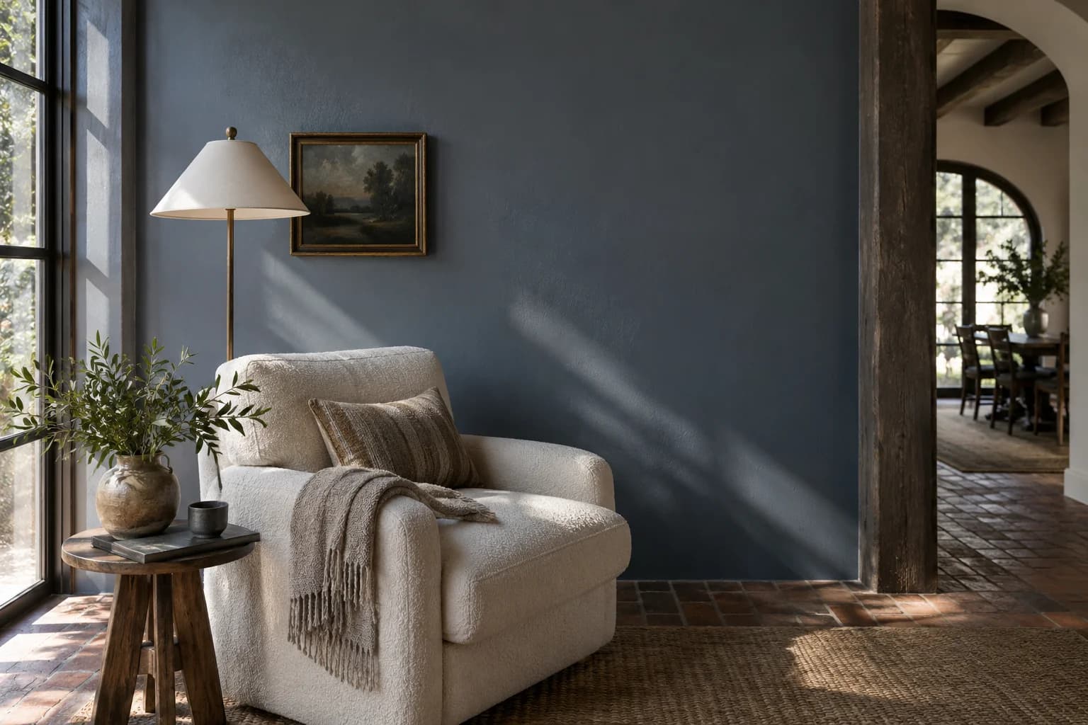 Reading nook with Blue Steel walls and a cream armchair