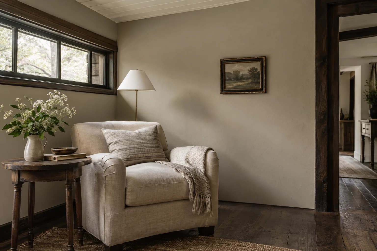 Reading nook with Stonehenge Greige walls and a cream armchair