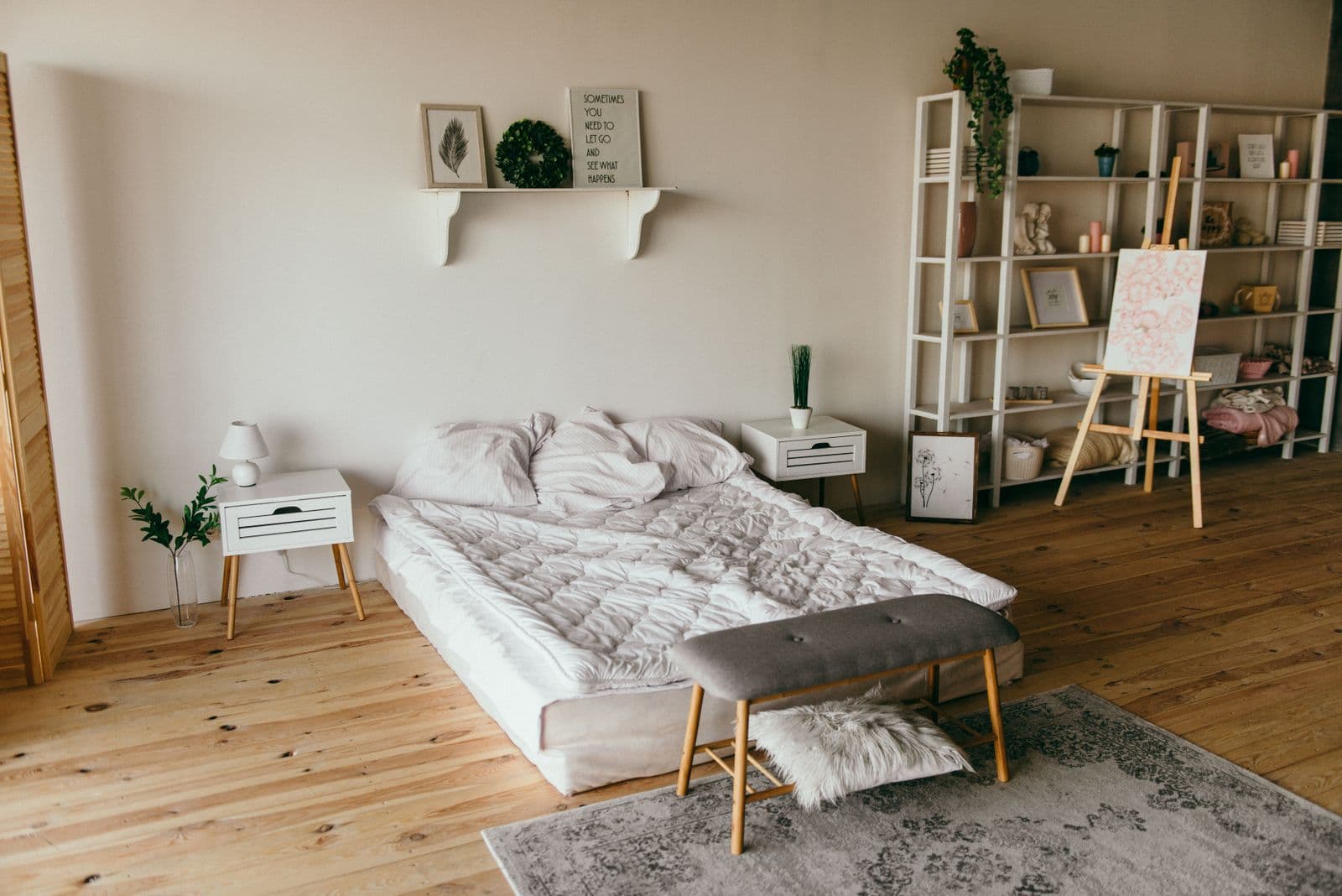 Bedroom with soft white walls and warm wood floors