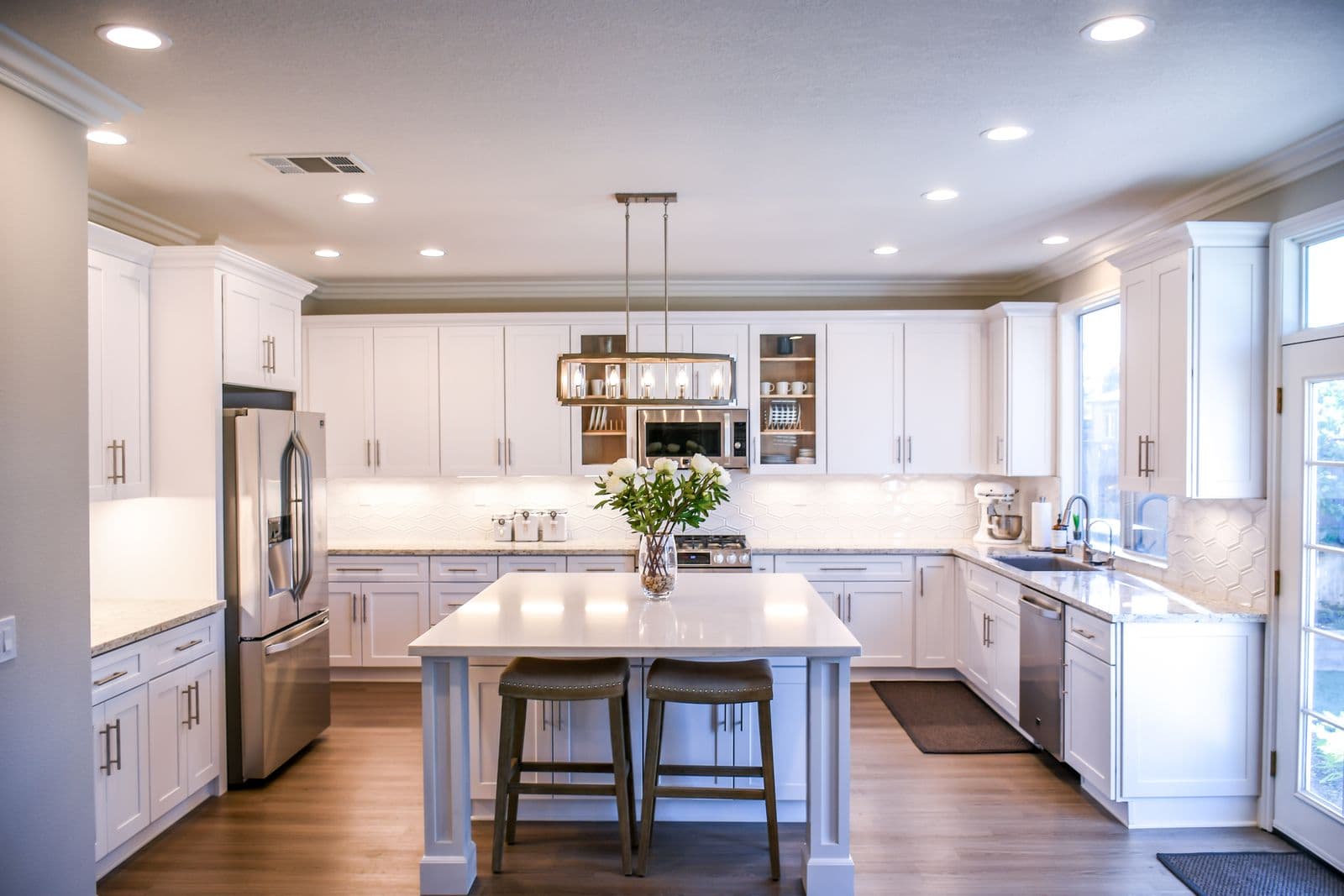 White kitchen with an island and pendant lighting