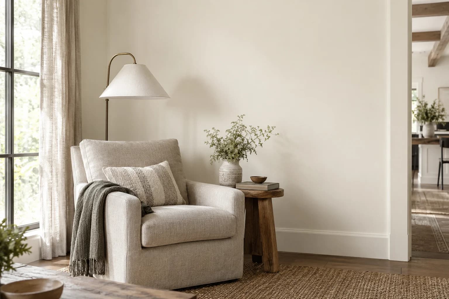 Reading nook with Blank Canvas walls and a cream armchair