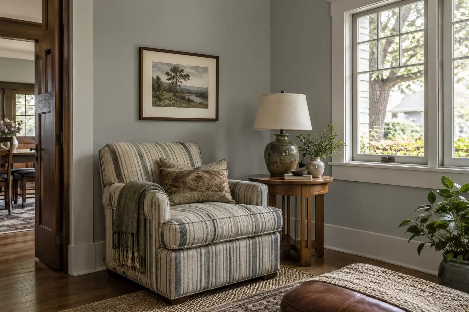 Reading nook with Coventry Gray walls and a cream armchair