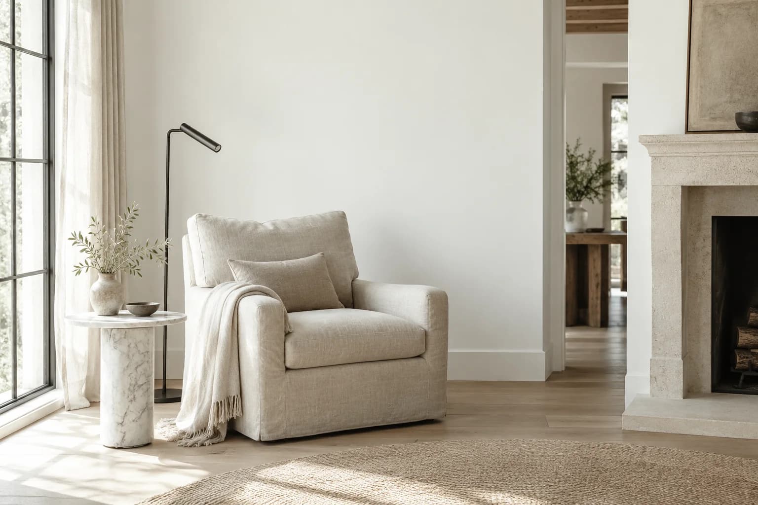 Reading nook with Delicate White walls and a cream armchair